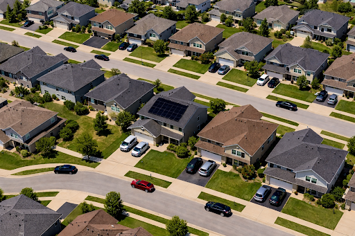Aerial view of suburban neighborhood with solar panels