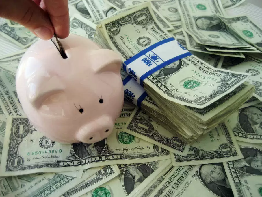 Piggy bank with money representing electrical upgrade savings