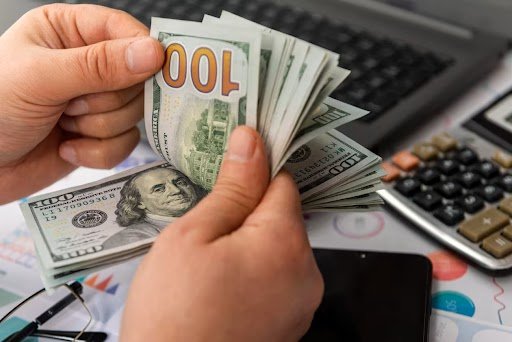 Counting money representing HVAC savings